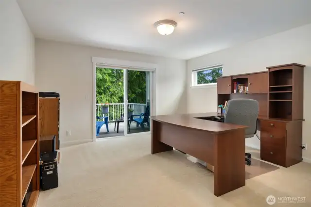The upper floor guest bedroom is being purposed as a den/office. Private deck access and a  great amount of closet space also makes for a wonderful guest retreat.
