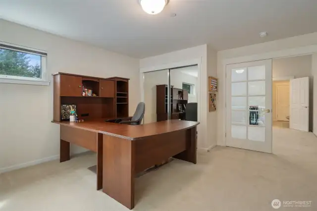 Looking back; a mirrored closet, and french doors lead to the bonus room.
