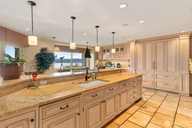 Ample countertop workspace, eating bar. Top quality cabinetry. Note the twin SubZero refrigerators each with dual pull out freezer compartments.