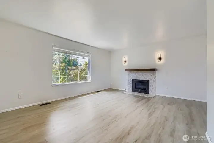 Bright, open living room with durable LVP flooring - no carpets throughout the house means less cleaning, more relaxing