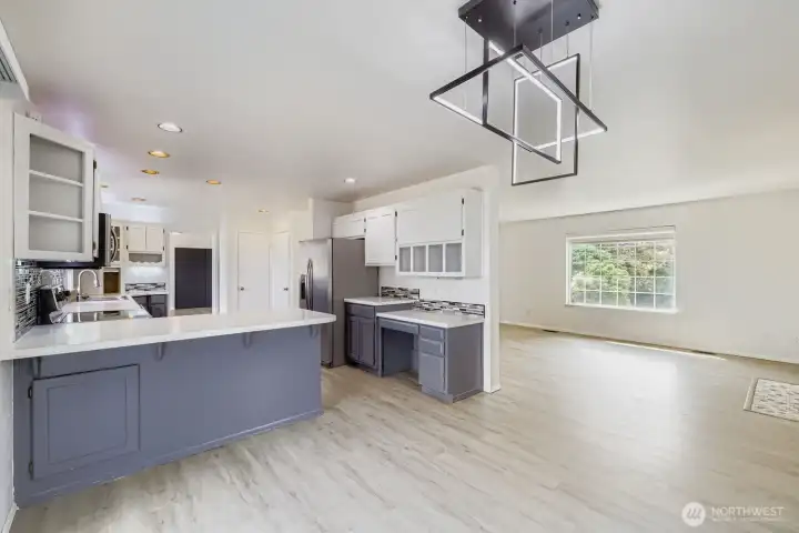 Seamless flow from living to dining, with bay windows, modern lighting & sliding patio door that opens to the oversized deck and expansive backyard retreat