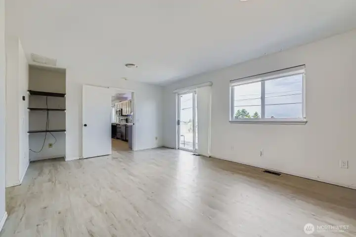 Light-filled family room with a second set of sliders leading to the expansive patio, indoor-outdoor living made easy