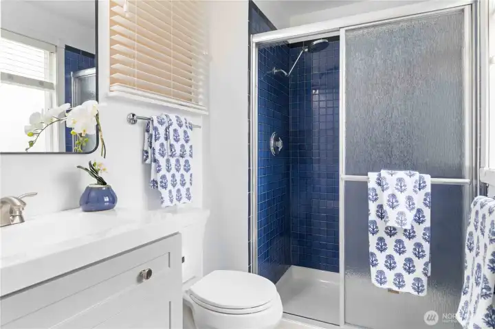 Enjoy this stylish primary bathroom featuring a tiled shower and modern finishes.