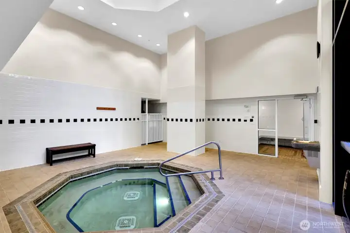 Modern spa features large hot tub and sauna.