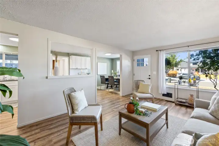 The living room room flows into the kitchen and dining room . Such a great floor plan!