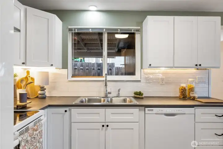 Notice the under the counter lighting! Beautiful tile backsplash too!