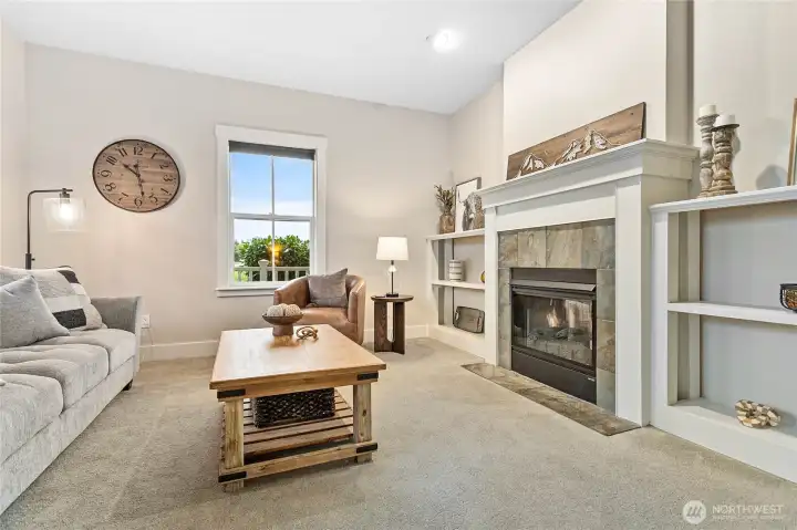 To the left as you enter the home, a charming den with cozy gas fireplace and built-ins.