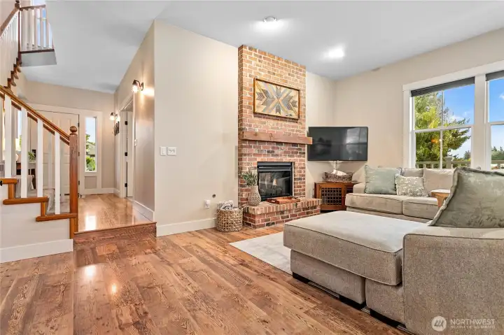 On the other side of the wall, you'll find the same gas fireplace in a comfortable livingroom.