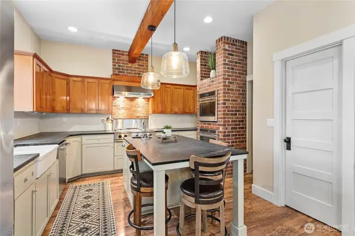 Walk-in pantry to the right. The exposed brick and beams really warm up the space.