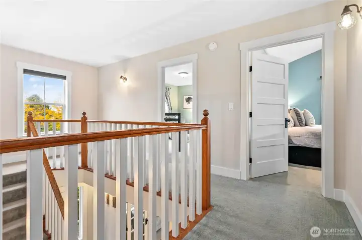 Here we have one of the guestrooms on the left and the primary bedroom to the right.