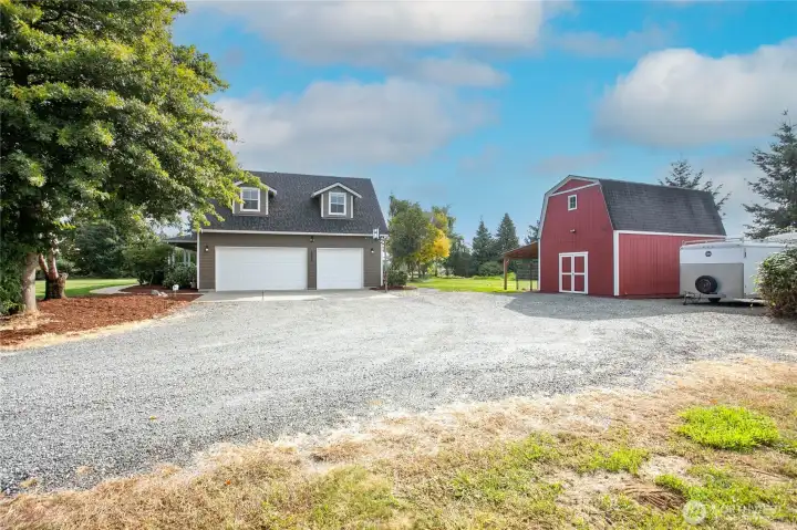 Plenty of parking in the 3-car garage, driveway, and gravel Blumefield Dr.