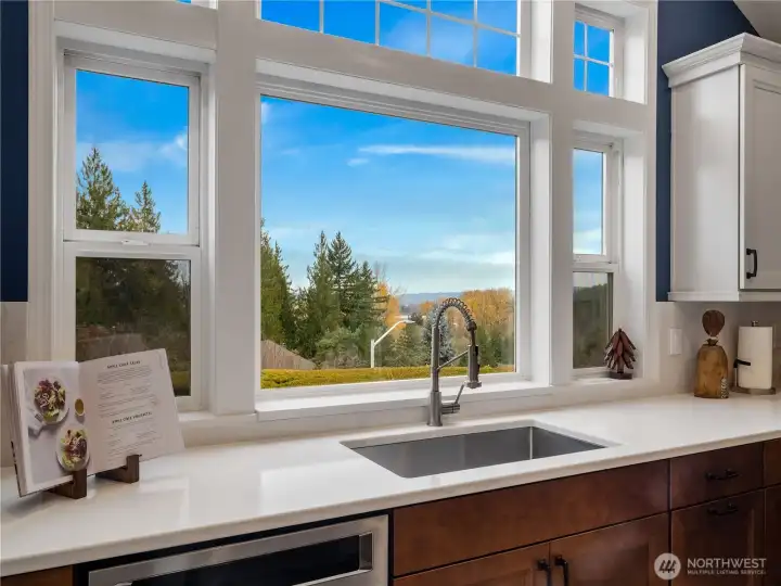 Enjoy scenic views while cooking, framed by expansive windows over the sink