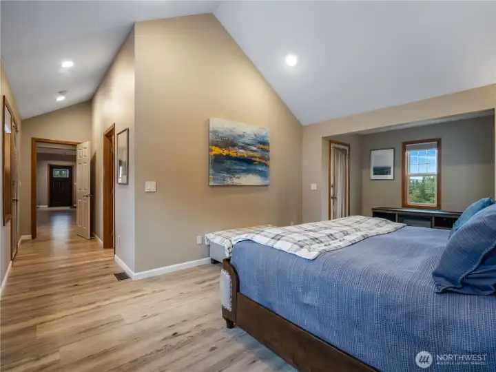 View from the primary bedroom toward the entry, passing the spacious walk-in closet and private ensuite