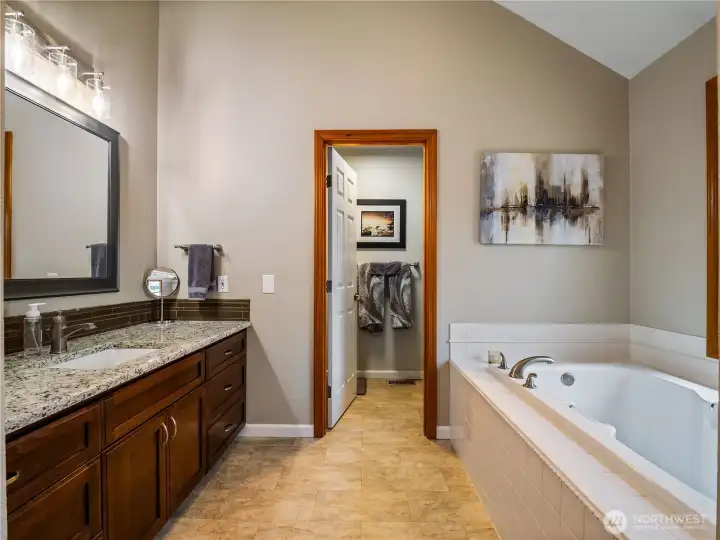 Remodeled primary ensuite featuring a large soaking tub, thoughtfully separated from the toilet and shower for added comfort and privacy