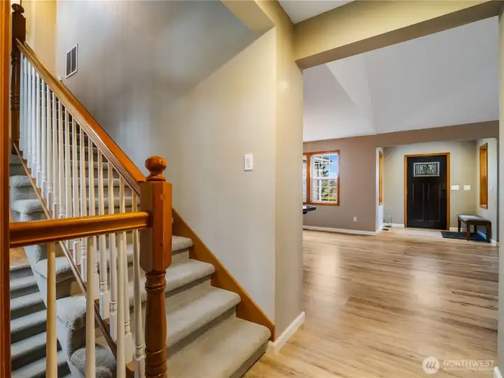 Staircase showcasing both the upper level and lower level access, reflecting the home’s well-designed layout