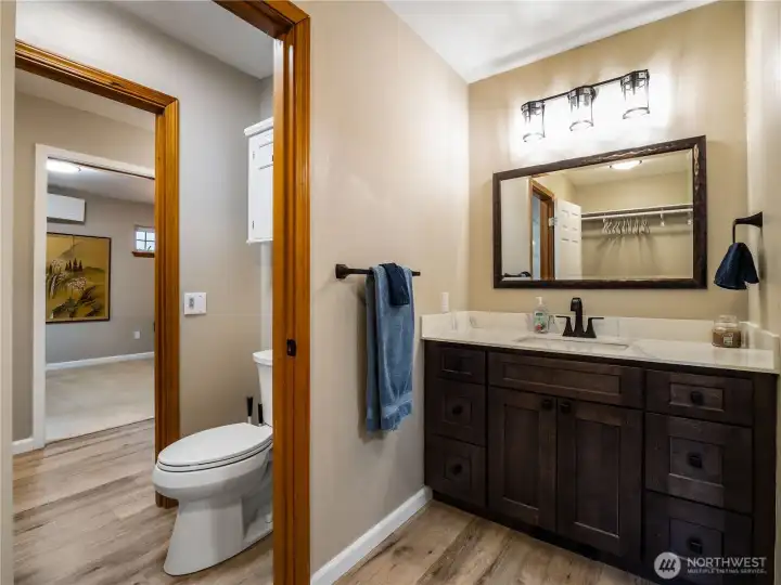 Bathroom with mirrored vanity located across from the walk-in closet for the second upstairs bedroom