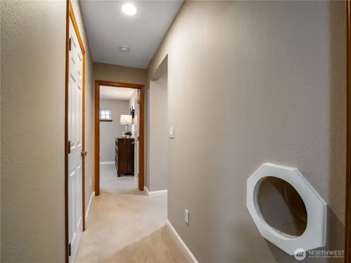 Upstairs hallway featuring a convenient built-in laundry chute