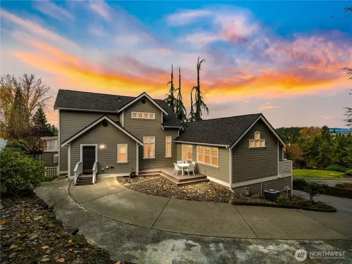 Backside of the home featuring an upper driveway that leads directly to the main level, making it easy to bring groceries straight inside