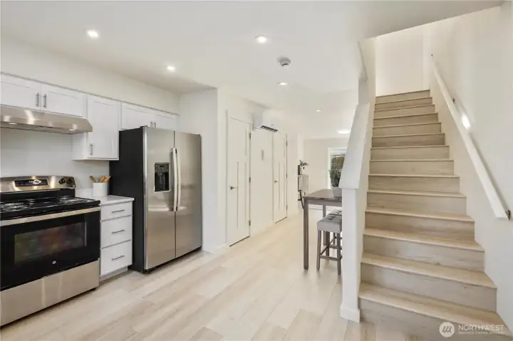 Welcoming main-level entry showcasing light wood flooring, modern finishes, and an open flow toward the living area.