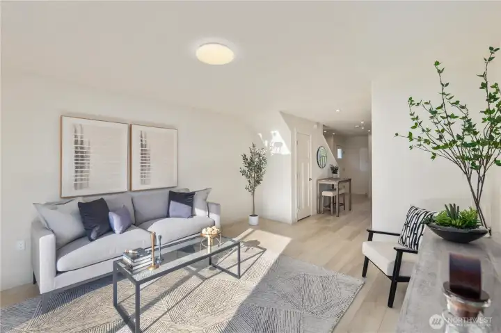 Open-concept main level featuring living room, kitchen, and dining area with modern finishes.