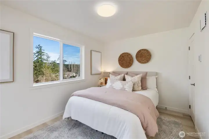 Additional upper-level bedroom with window views and flexible use for guests, office, or additional living space.