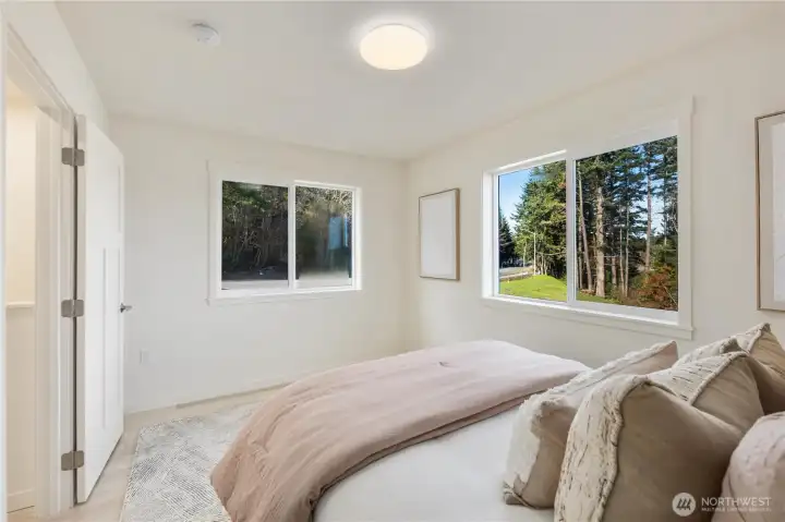 Bright bedroom with dual windows bringing in natural island light.
