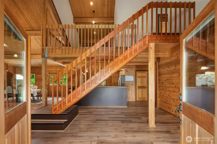 Grand entryway leading to open concept main living area.