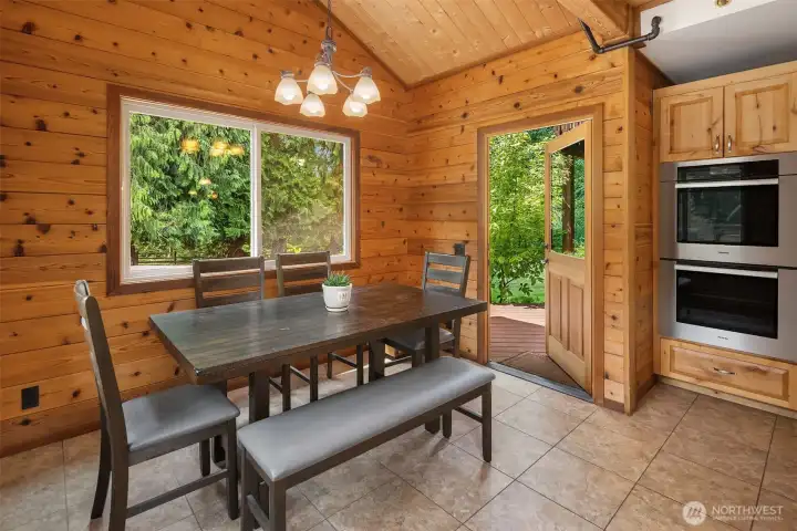 Eating nook off of kitchen with direct access to back deck.