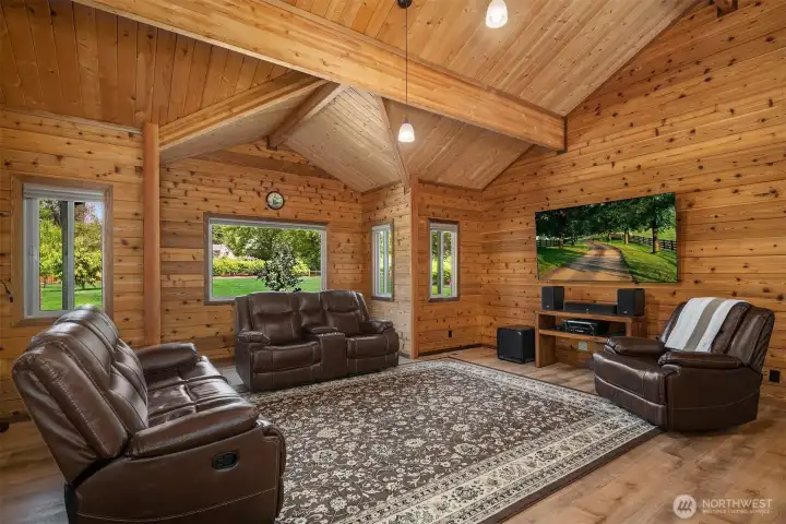 Living room framed with large windows allowing ample natural light to fill the space.