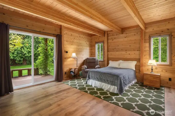 Primary bedroom, main floor with direct access to deck & hot tub via sliding glass doors.