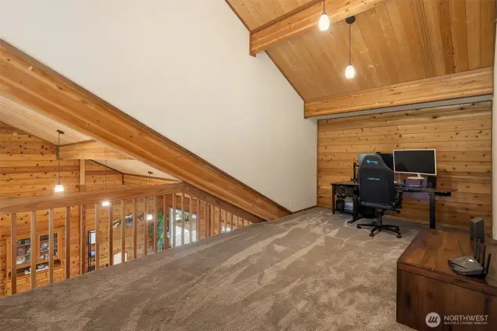 Landing loft area on top of stairs looking over main living space.