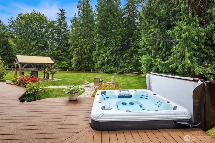 Backyard deck & hot tub that stays with the home.