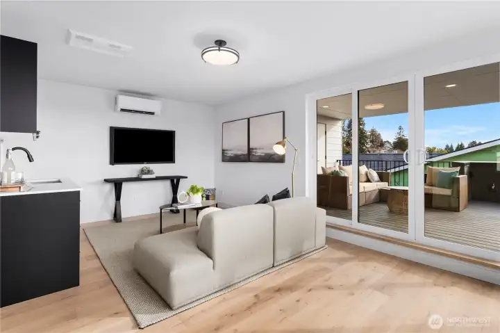 3rd level main living area with sliding doors to large outdoor deck with views