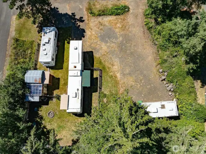 Corner lot with mature trees on the north side of the property. the two smaller RV's will be removed before closing.