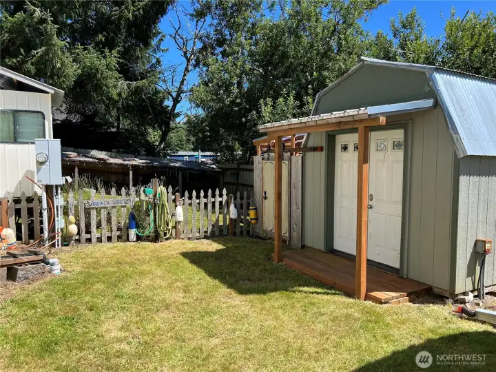 The backyard is completely fenced in for your furry companions. Septic hookups and electrical meter left side of photo.
