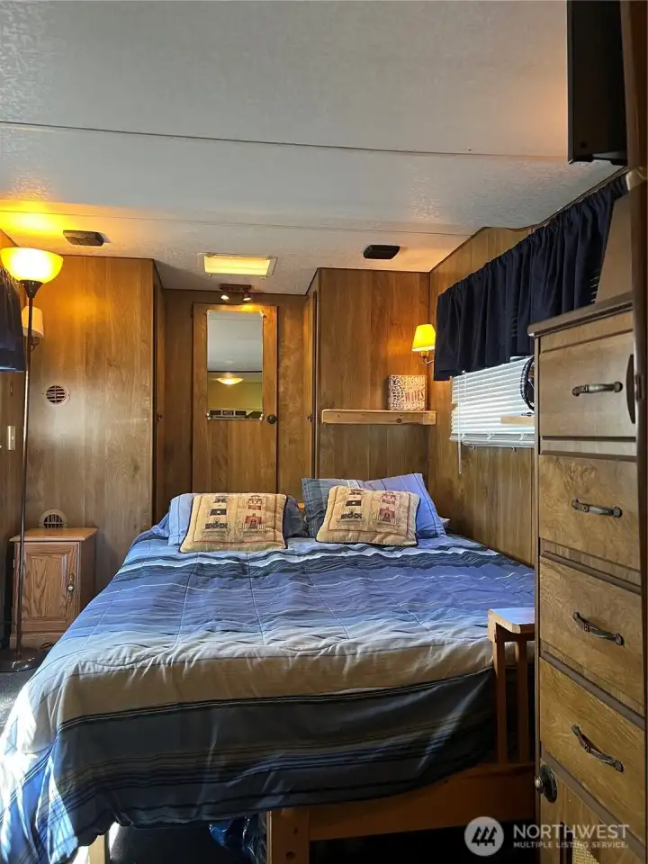 Queen size bed fits comfortably. Lots of storage with built-in dresser and closet.