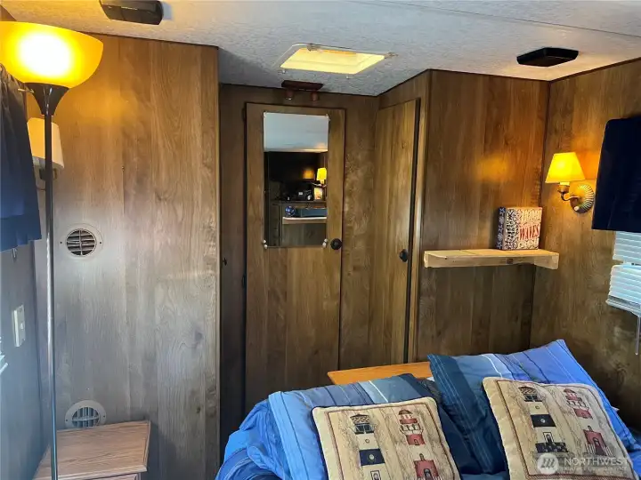 The closet has three doors to for lots of clothes and shoes.