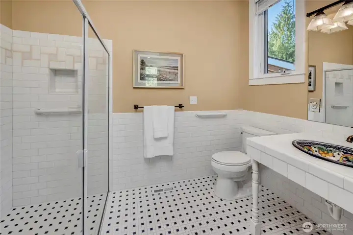 In-suite bath with level shower entrance.