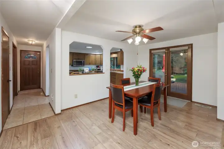 Dining area w/ French doors to entertainment sized partially covered  deck.