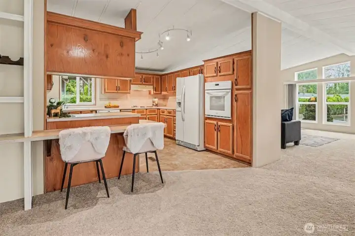 Classic charm meets functional design. This heart-of-the-home features honey-oak cabinetry and a peninsula perfect for prep work or casual dining