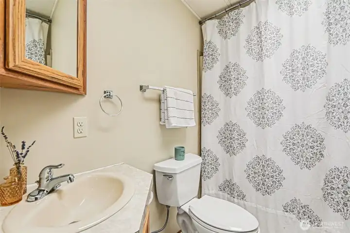 A bright, well-maintained bathroom featuring a neutral palette