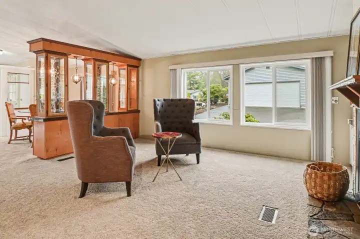 The Ultimate Conversation Starter: This open-concept living area features a stunning built-in wet bar with leaded glass details—perfect for hosting cocktail hour or displaying your finest collection.