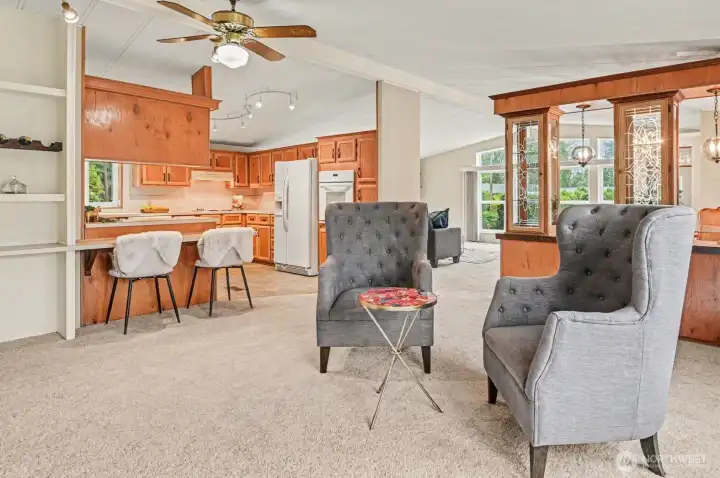 Featuring plush carpeting and a spacious layout, this versatile living room is designed for both quiet relaxation and grand entertaining