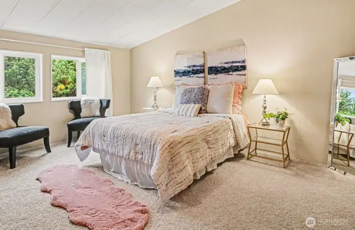 Primary Bedroom - A true retreat. This spacious primary suite offers a serene atmosphere with soft natural light, plush carpeting…