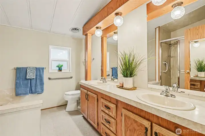 Start your morning in style. This expansive bathroom boasts a massive double vanity with ample storage and integrated lighting