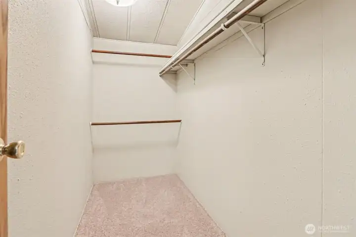 Organization made easy. This sizable walk-in closet provides plenty of hanging space and shelving to keep your wardrobe tidy and accessible