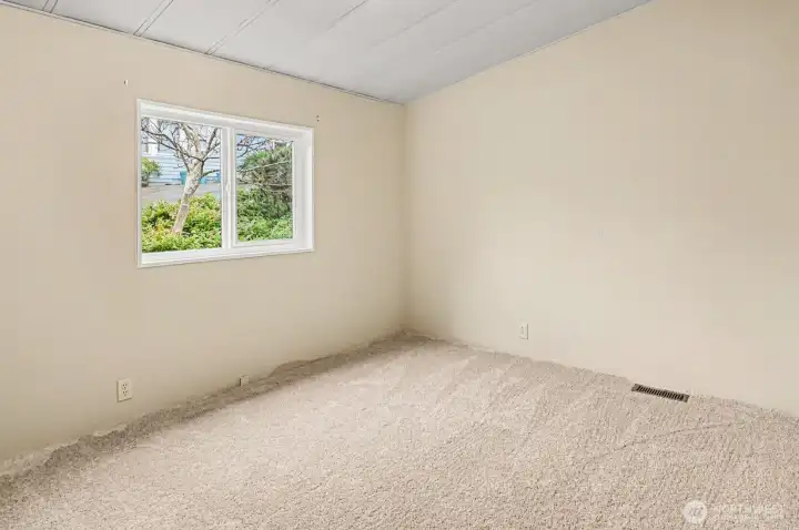 Comfortable and versatile. These second and third bedrooms features large windows that frame peaceful outdoor views…