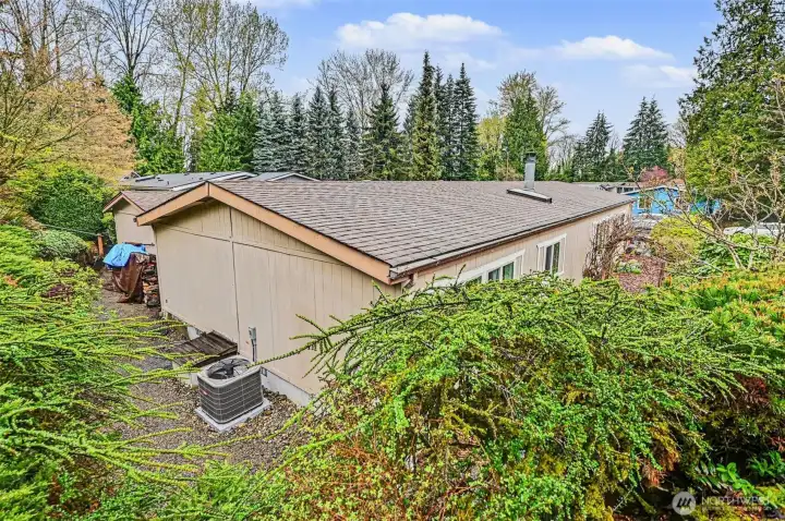 Tucked away in a lush, green setting, this home offers the perfect blend of privacy and tranquility, all framed by a beautiful backdrop of mature evergreens