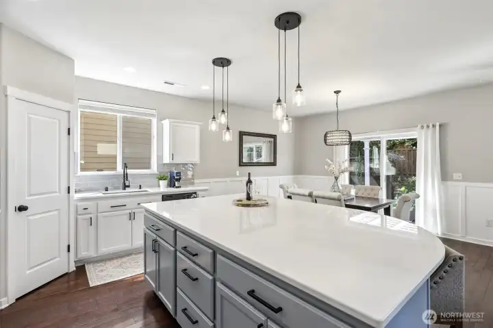 Island kitchen leading to dining room