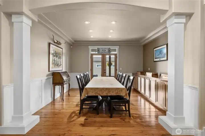 Dining room with French Doors to back patio with built-ins and Custom Wood Flooring through out!